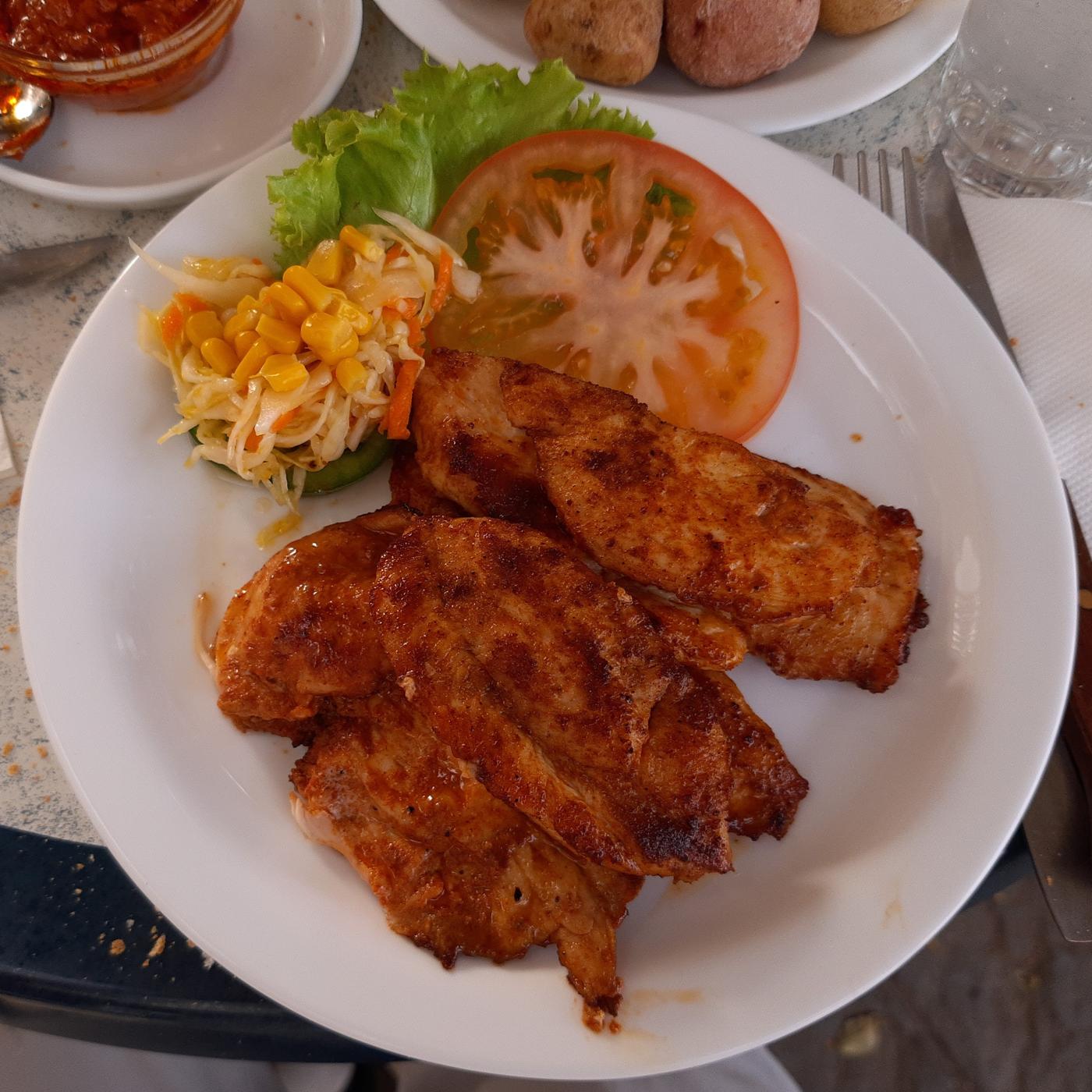 Grilled chicken breast served with vegetables